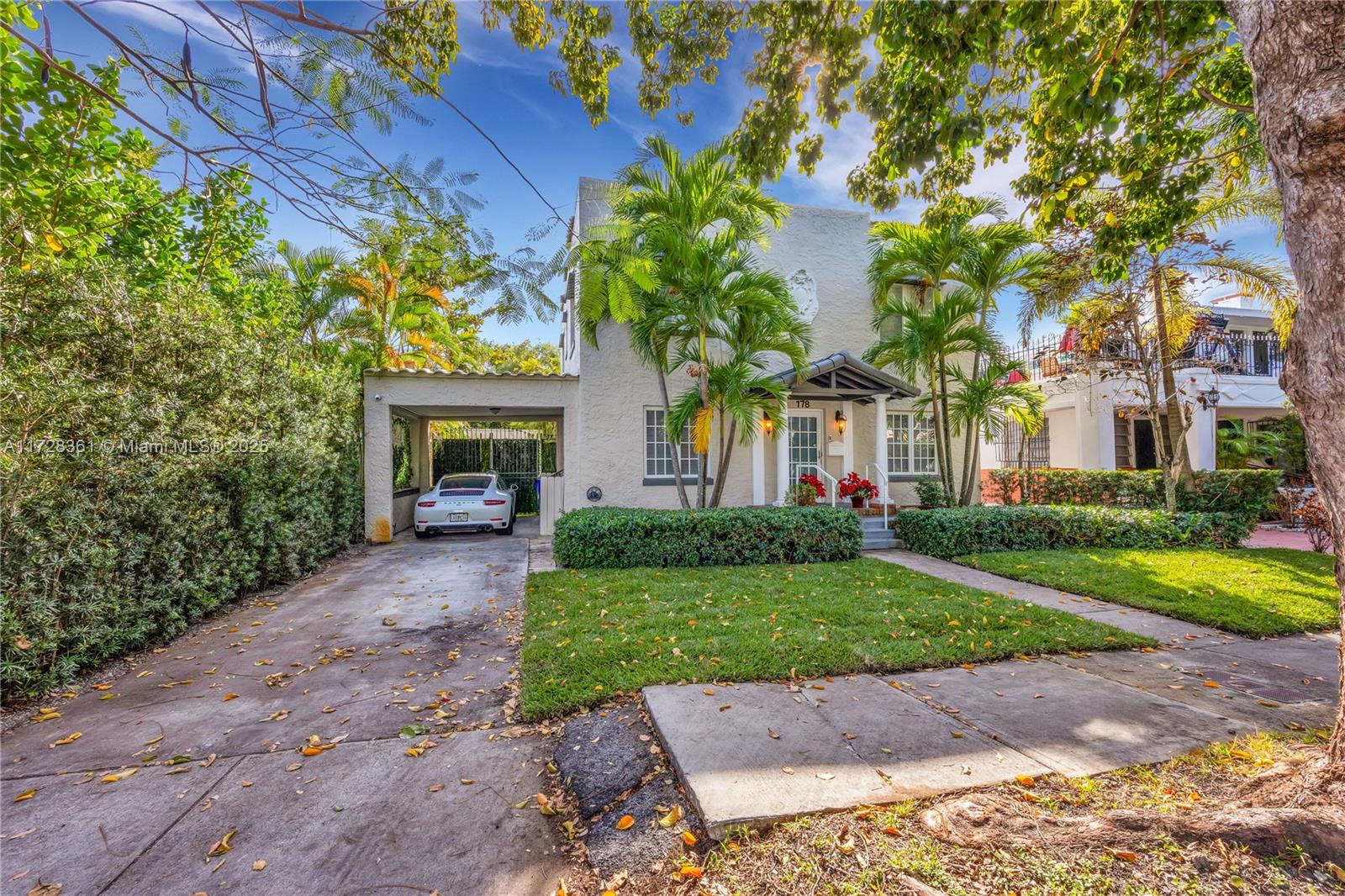 178 Northeast 45th Street Miami, FL 33137 - Photo 38 of 47 a front view of a house with a garden and trees