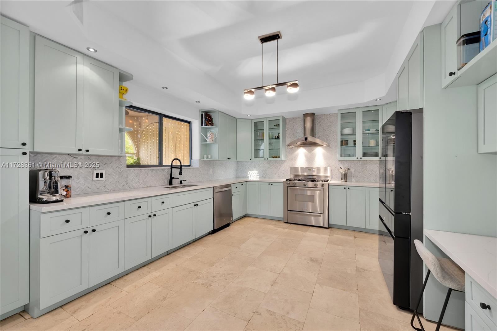 178 Northeast 45th Street Miami, FL 33137 - Photo 8 of 47 a kitchen with granite countertop white cabinets and stainless steel appliances
