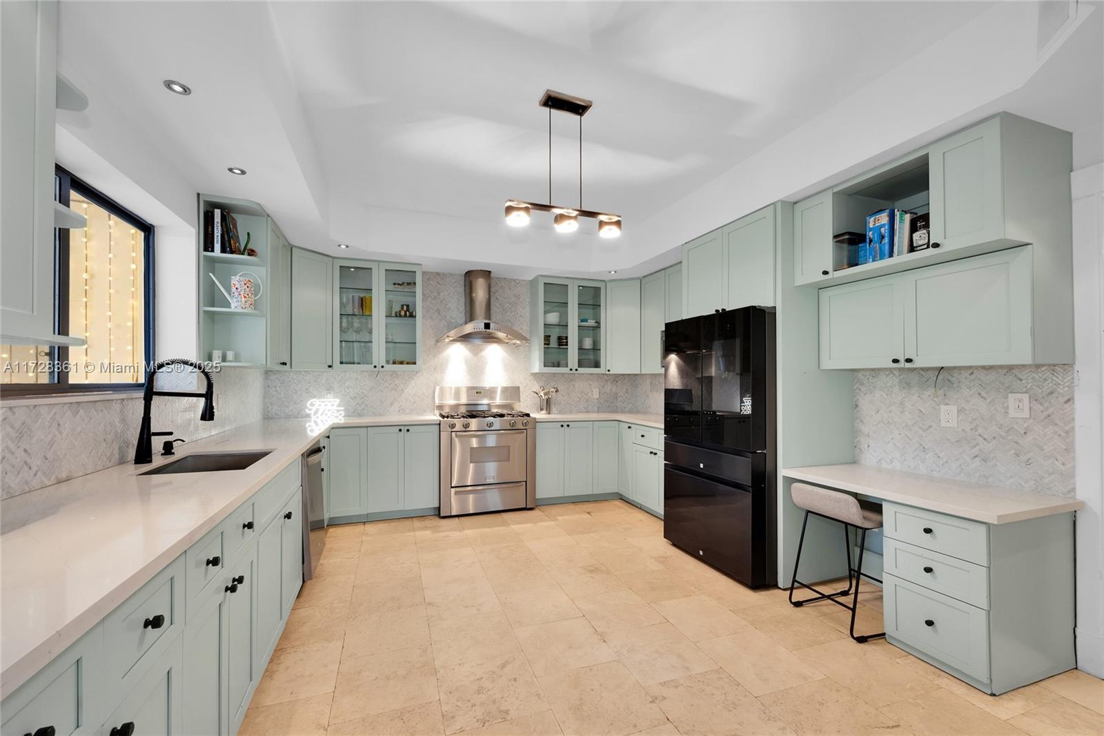 178 Northeast 45th Street Miami, FL 33137 - Photo 9 of 47 a kitchen with white cabinets and stainless steel appliances