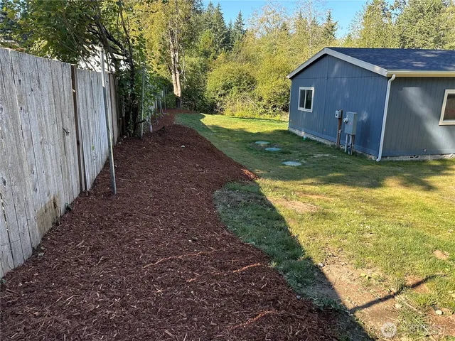 a view of a backyard with swimming pool