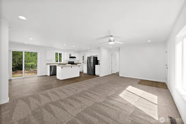 a view of a kitchen with a sink and an open kitchen view