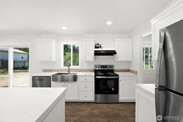 a kitchen with a refrigerator stove and sink