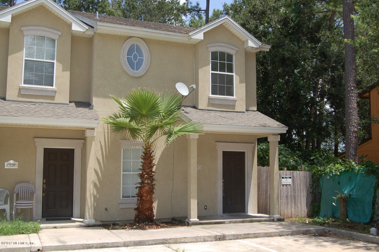 4693 Barnes Road South Jacksonville, FL 32207 - Photo 1 of 12 a front view of a house with garden