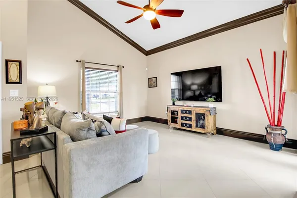 a living room with furniture and a flat screen tv