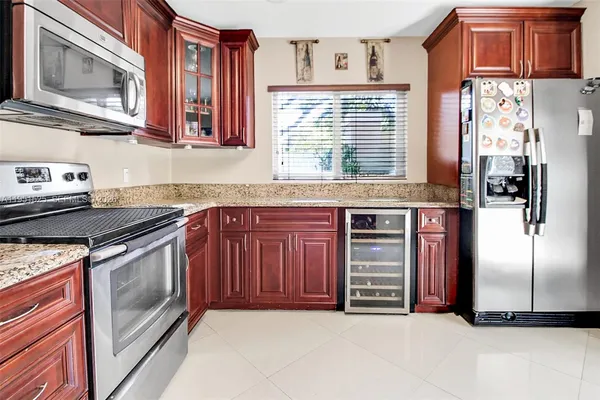 a kitchen with a stove top oven and sink