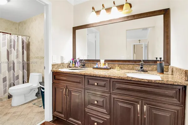 a white toilet sitting next to a shower curtain