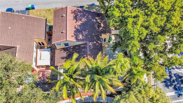 an aerial view of a house with a yard