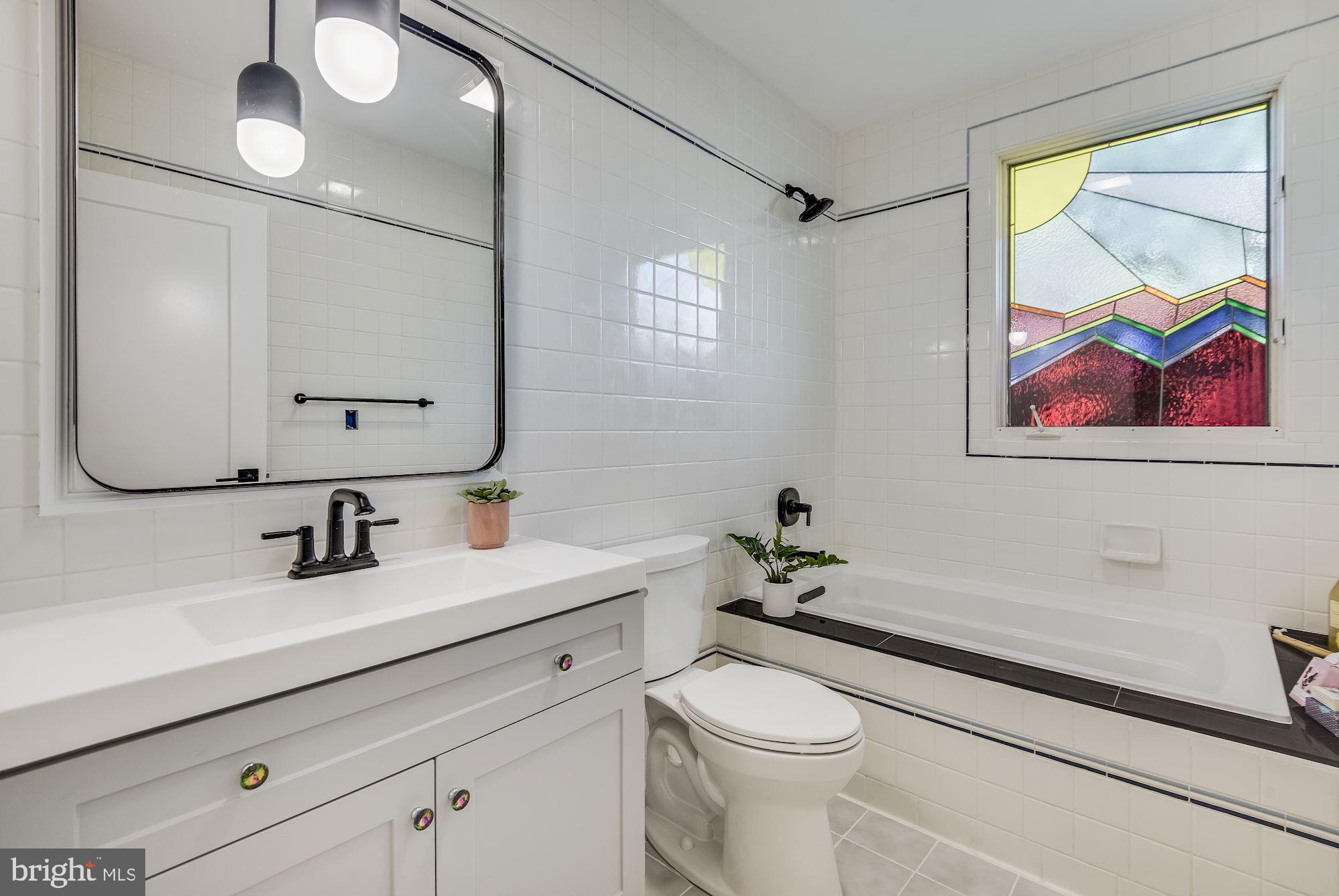 17 Ritchie Avenue Silver Spring, MD 20910 - Photo 20 of 38 Hall bath continues the stained glass theme.