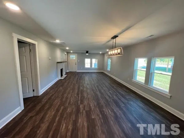 a view of wooden floor and windows in an empty room