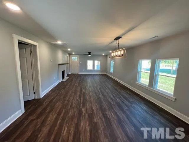 a view of wooden floor and windows in an empty room