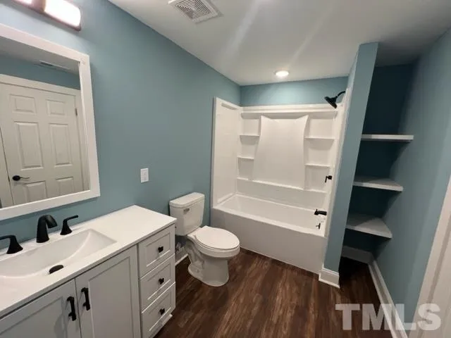 a bathroom with a sink a toilet a shower and a mirror