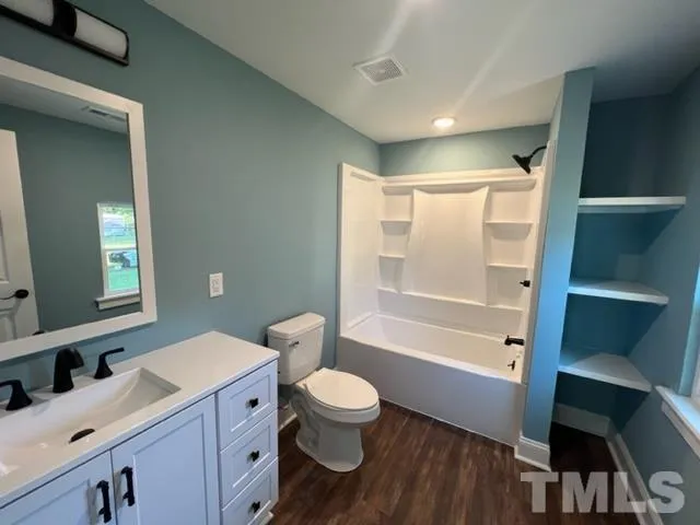 a bathroom with a toilet a sink and a bathtub