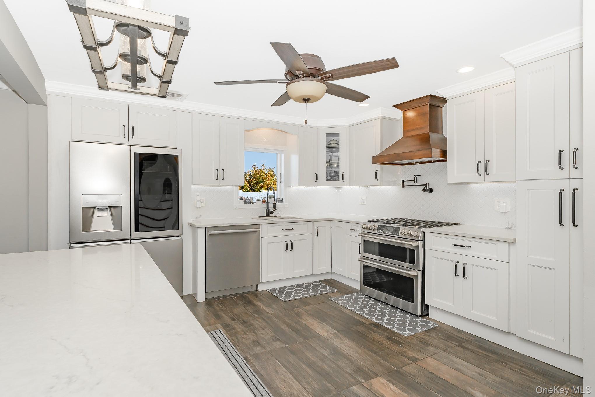 2431 Riverside Drive Wantagh, NY 11793 - Photo 12 of 23 a kitchen with a stove a sink and a refrigerator