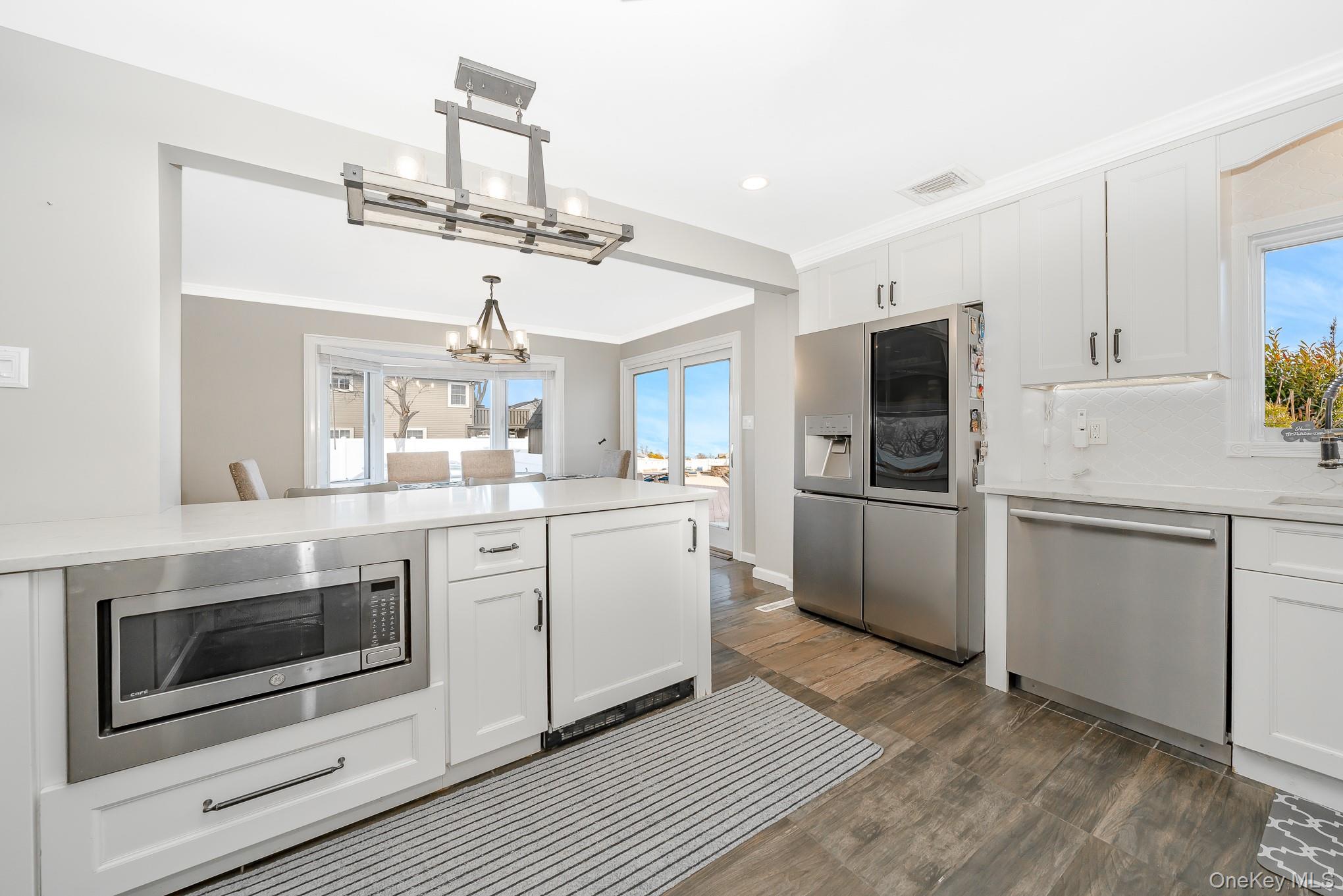 2431 Riverside Drive Wantagh, NY 11793 - Photo 13 of 23 a kitchen with a sink stainless steel appliances and cabinets