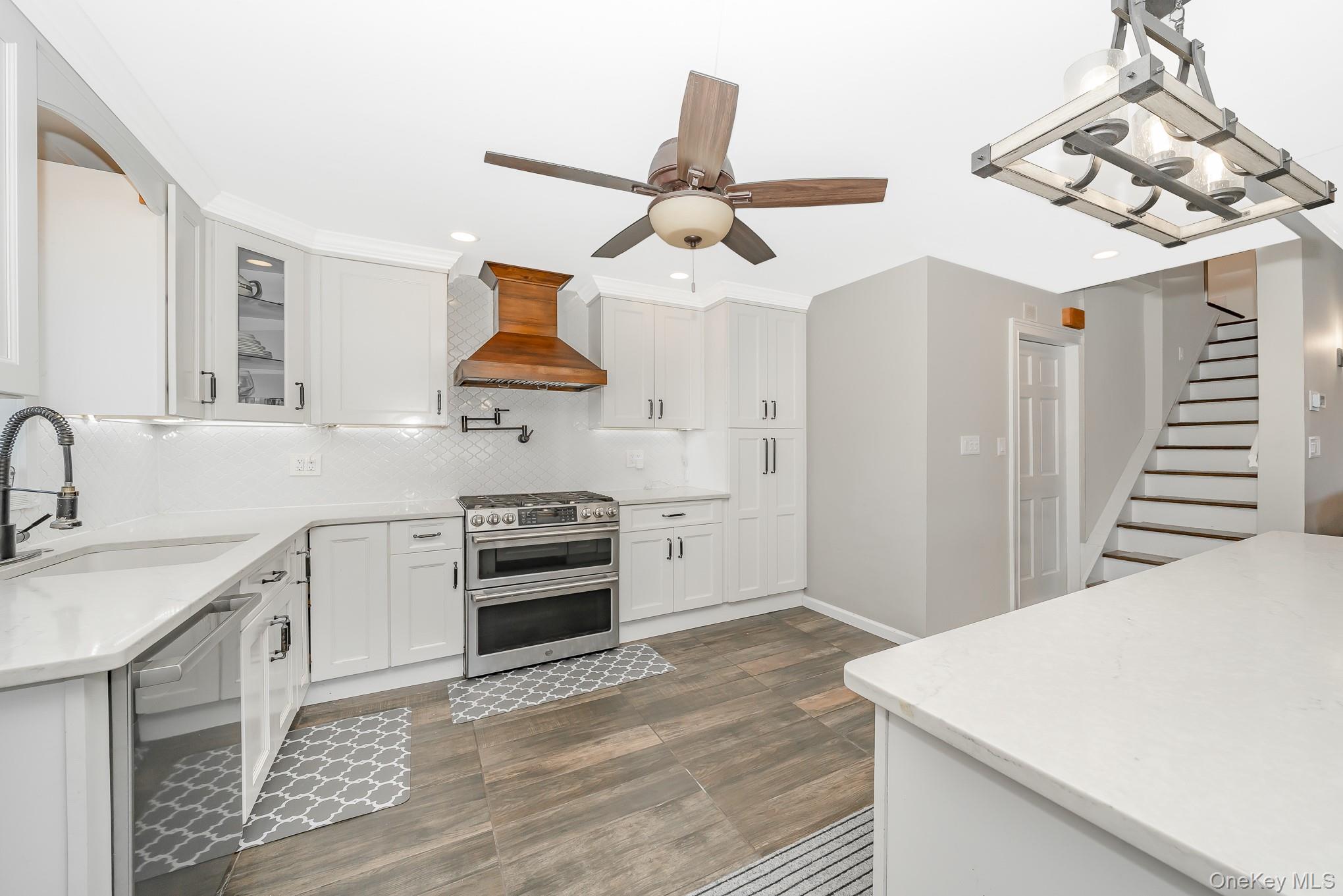 2431 Riverside Drive Wantagh, NY 11793 - Photo 14 of 23 a kitchen with stainless steel appliances a stove a sink and a refrigerator