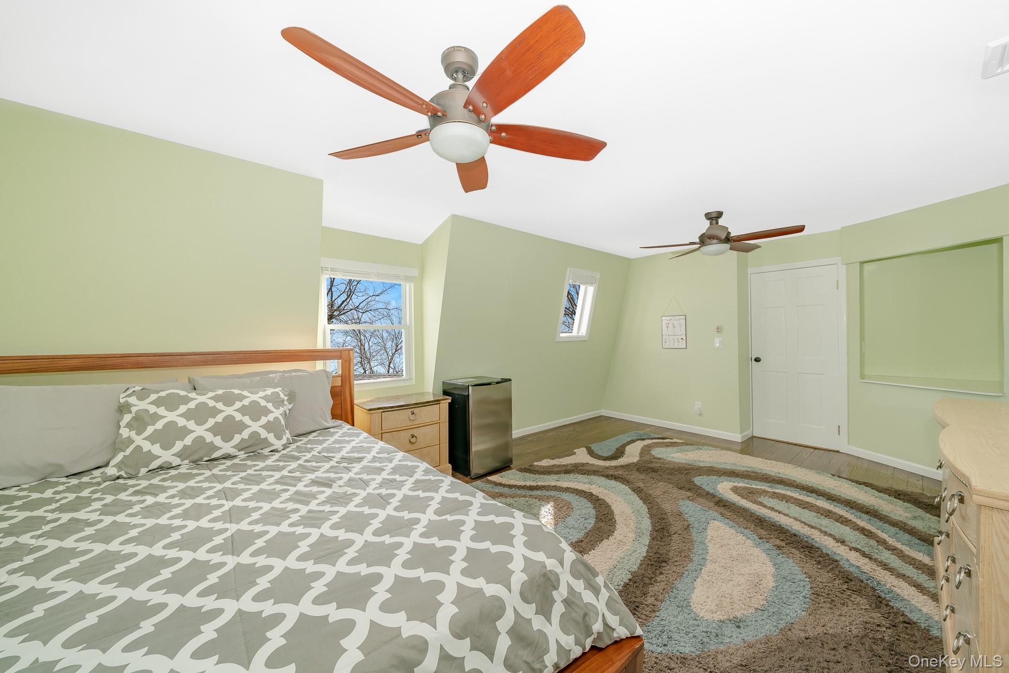 2431 Riverside Drive Wantagh, NY 11793 - Photo 15 of 23 a bedroom with a bed and a chandelier