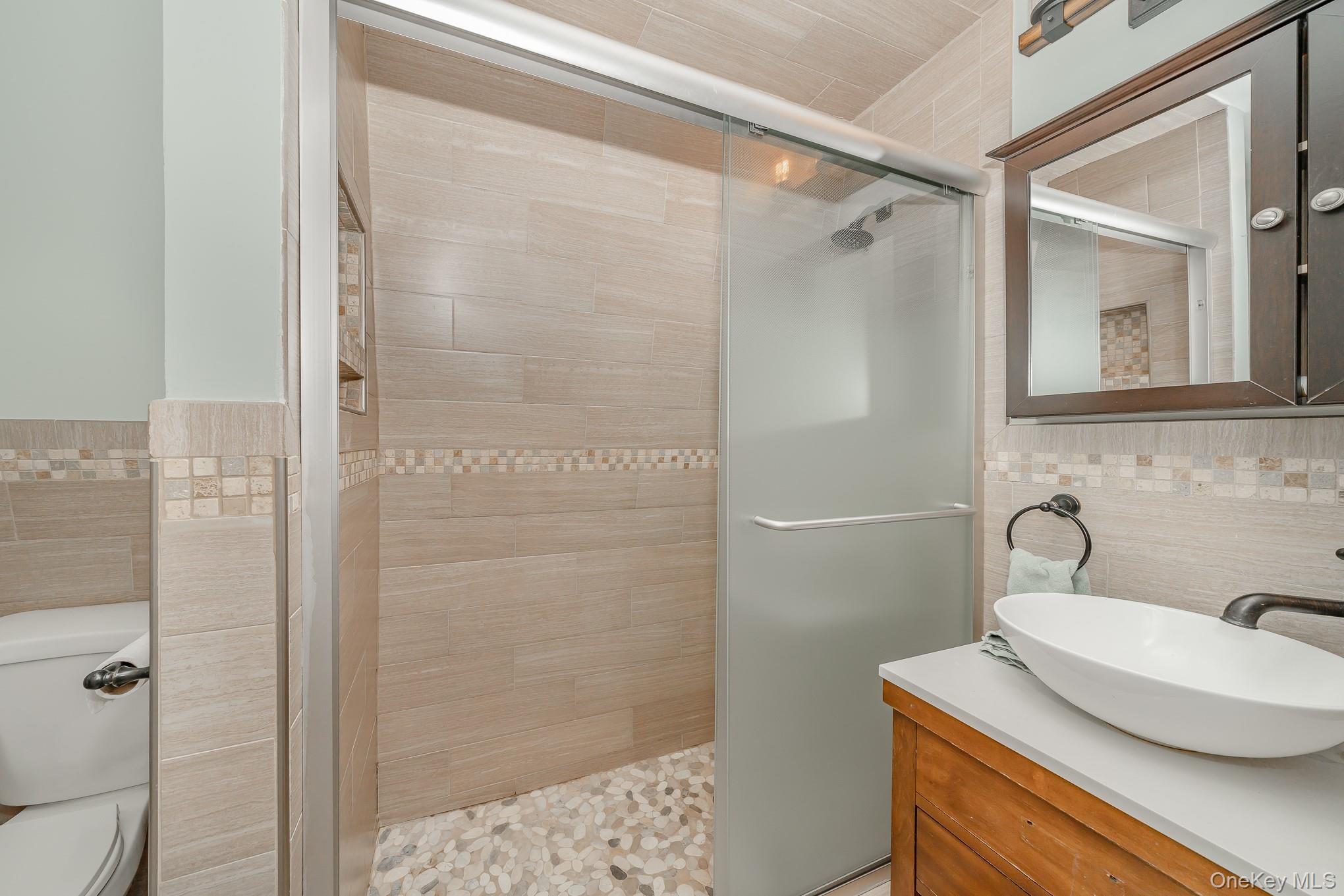 2431 Riverside Drive Wantagh, NY 11793 - Photo 17 of 23 a bathroom with a granite countertop shower sink vanity and toilet