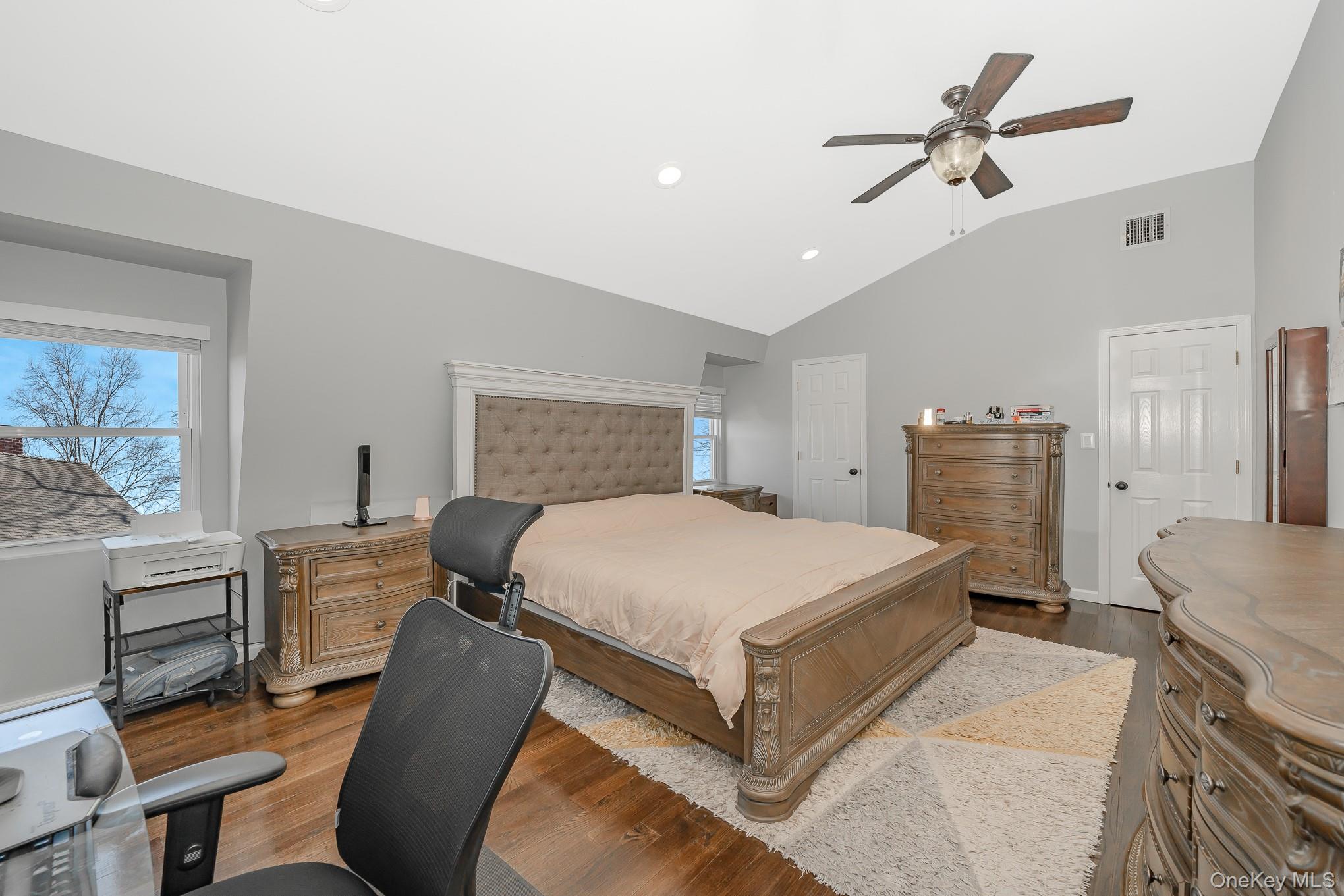 2431 Riverside Drive Wantagh, NY 11793 - Photo 18 of 23 a bedroom with a bed and a chandelier