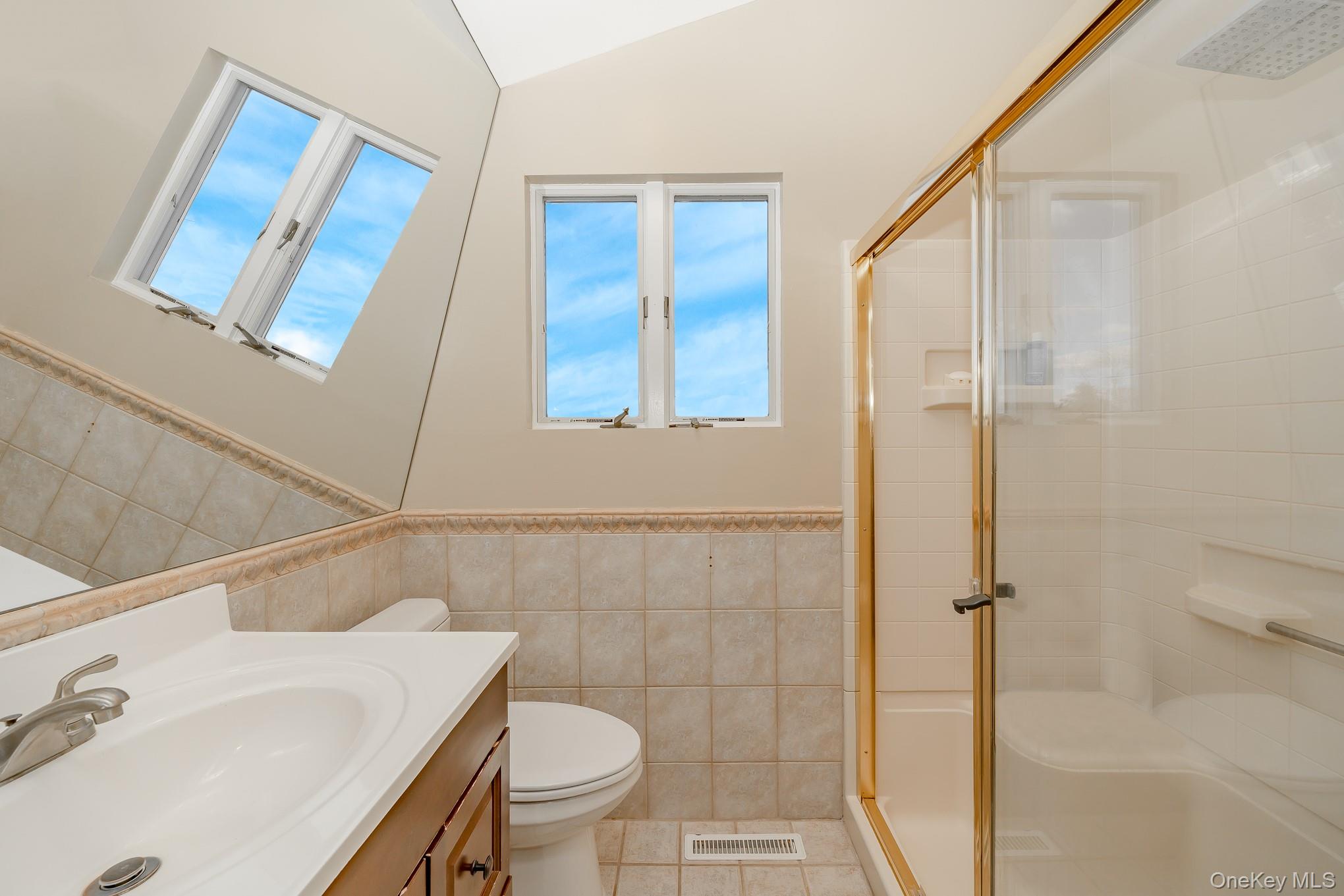 2431 Riverside Drive Wantagh, NY 11793 - Photo 19 of 23 a bathroom with a sink toilet and shower