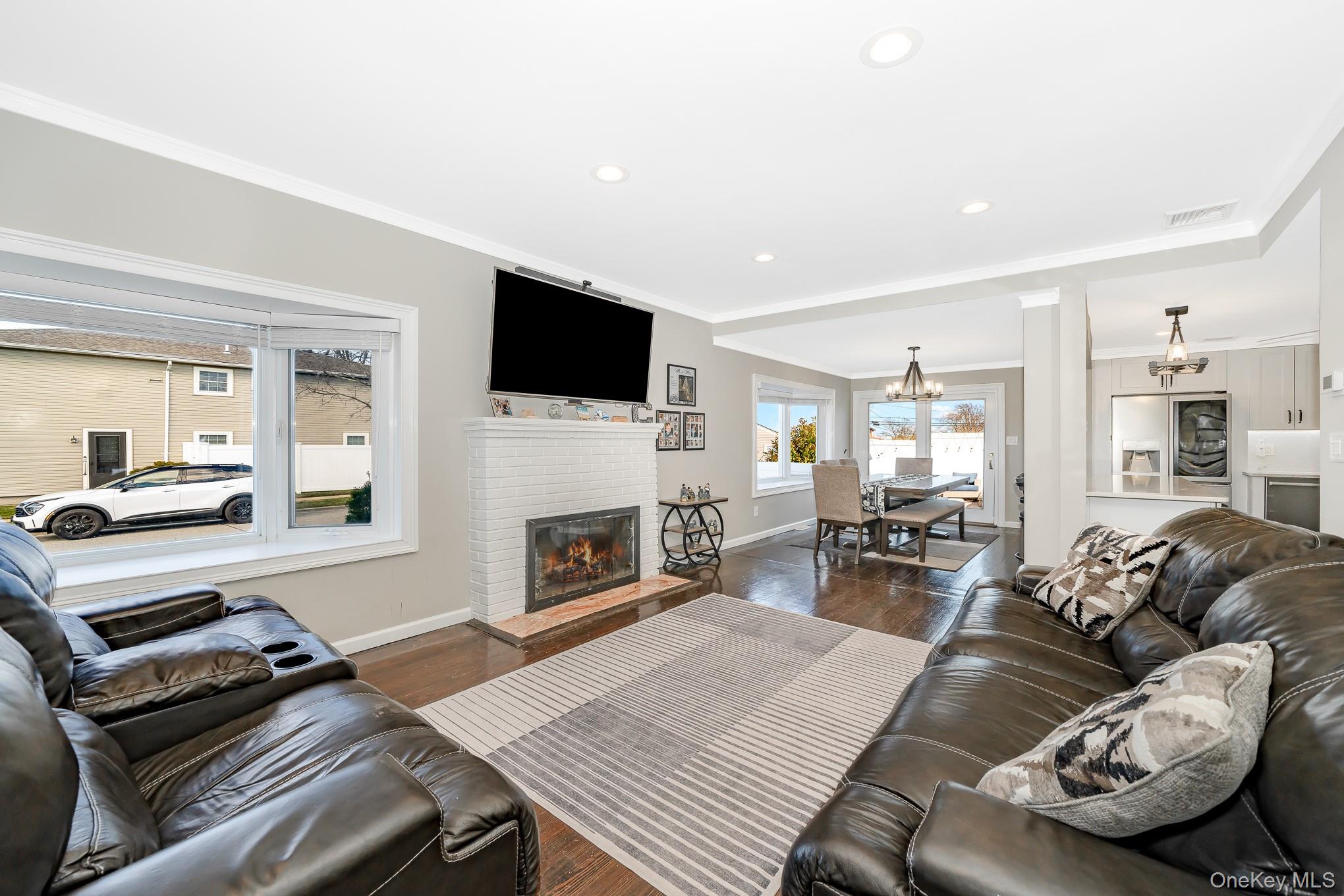 2431 Riverside Drive Wantagh, NY 11793 - Photo 8 of 23 a living room with furniture a fireplace and a flat screen tv