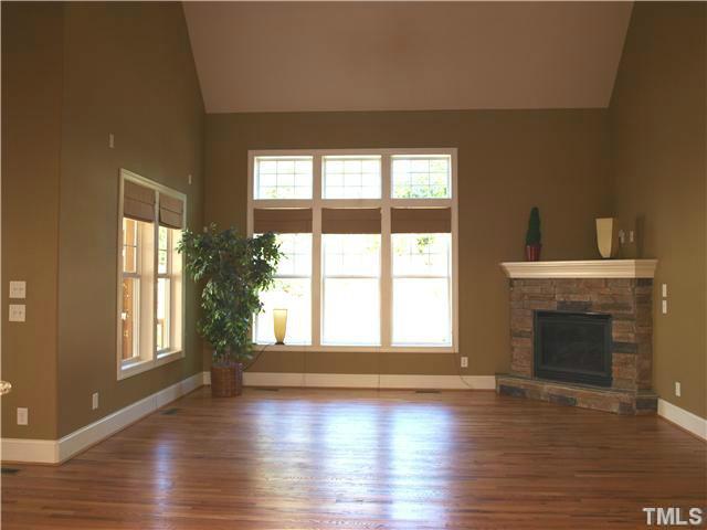 12316 Beestone Lane Raleigh, NC 27614 - Photo 4 of 20 a view of an empty room with wooden floor and a window