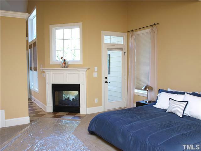 12316 Beestone Lane Raleigh, NC 27614 - Photo 9 of 20 a bedroom with a bed and a fireplace