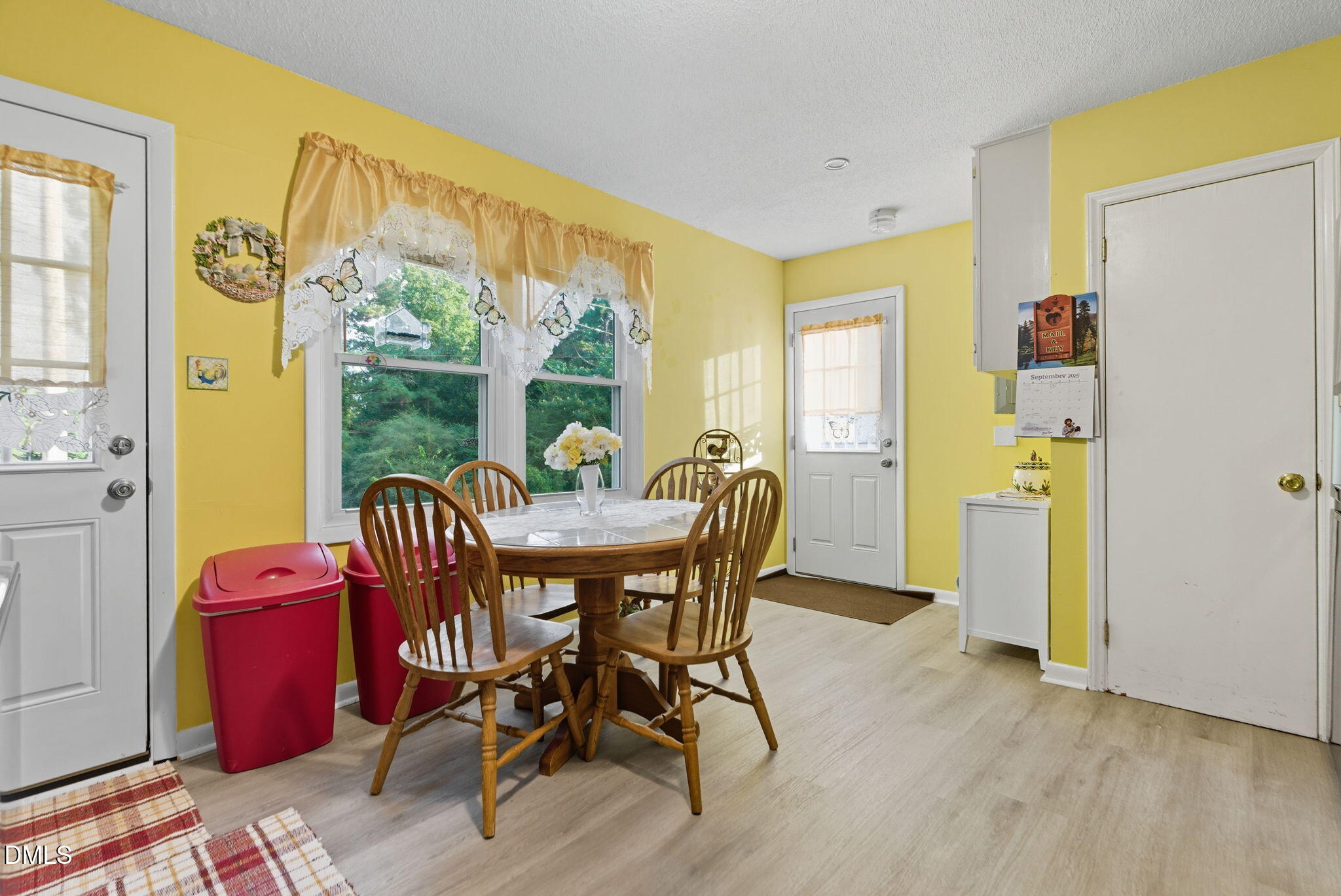 1412 Parks Village Road Zebulon, NC 27597 - Photo 11 of 40 a view of a dining room with furniture window and wooden floor