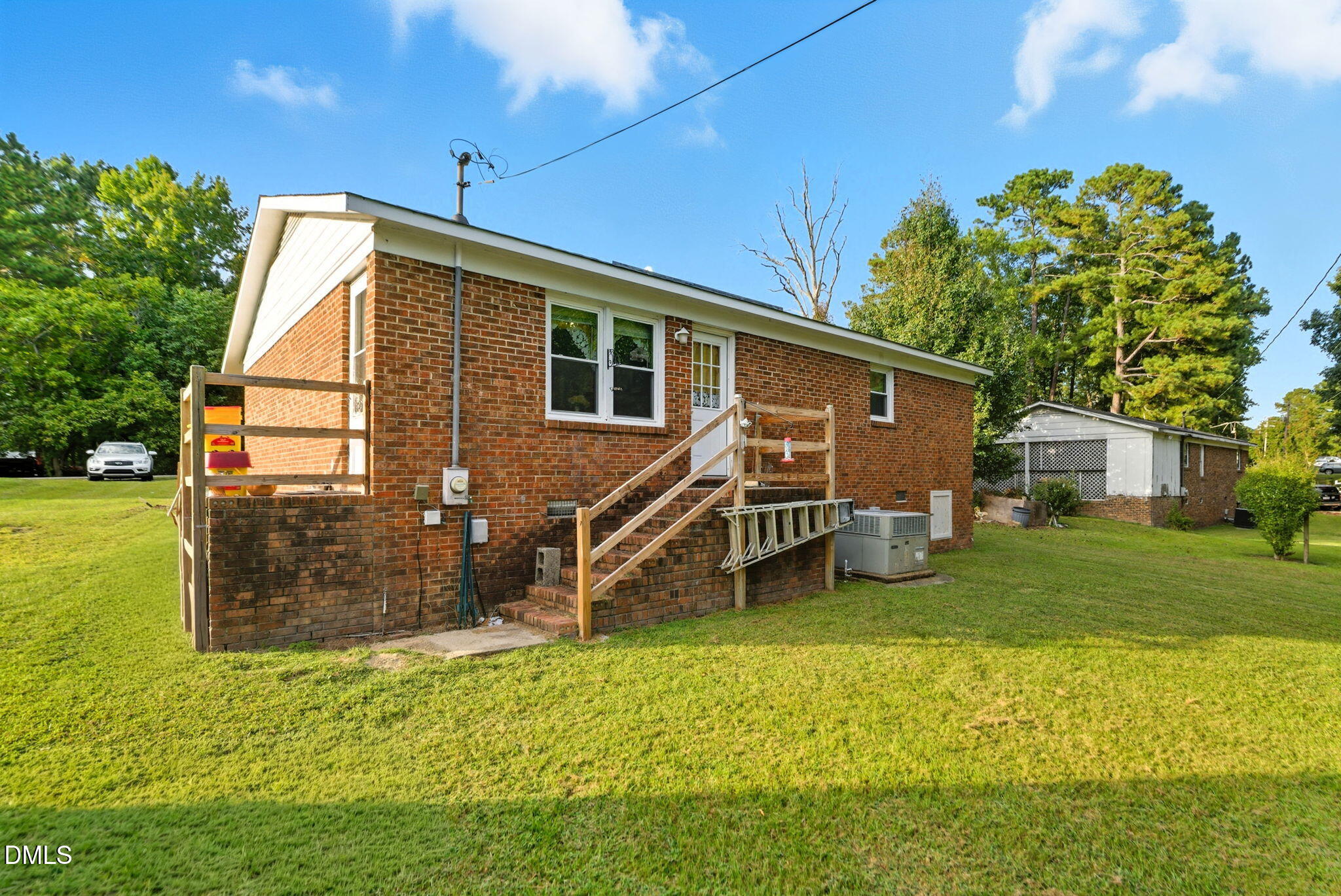 1412 Parks Village Road Zebulon, NC 27597 - Photo 33 of 40 a backyard of a house with table and chairs