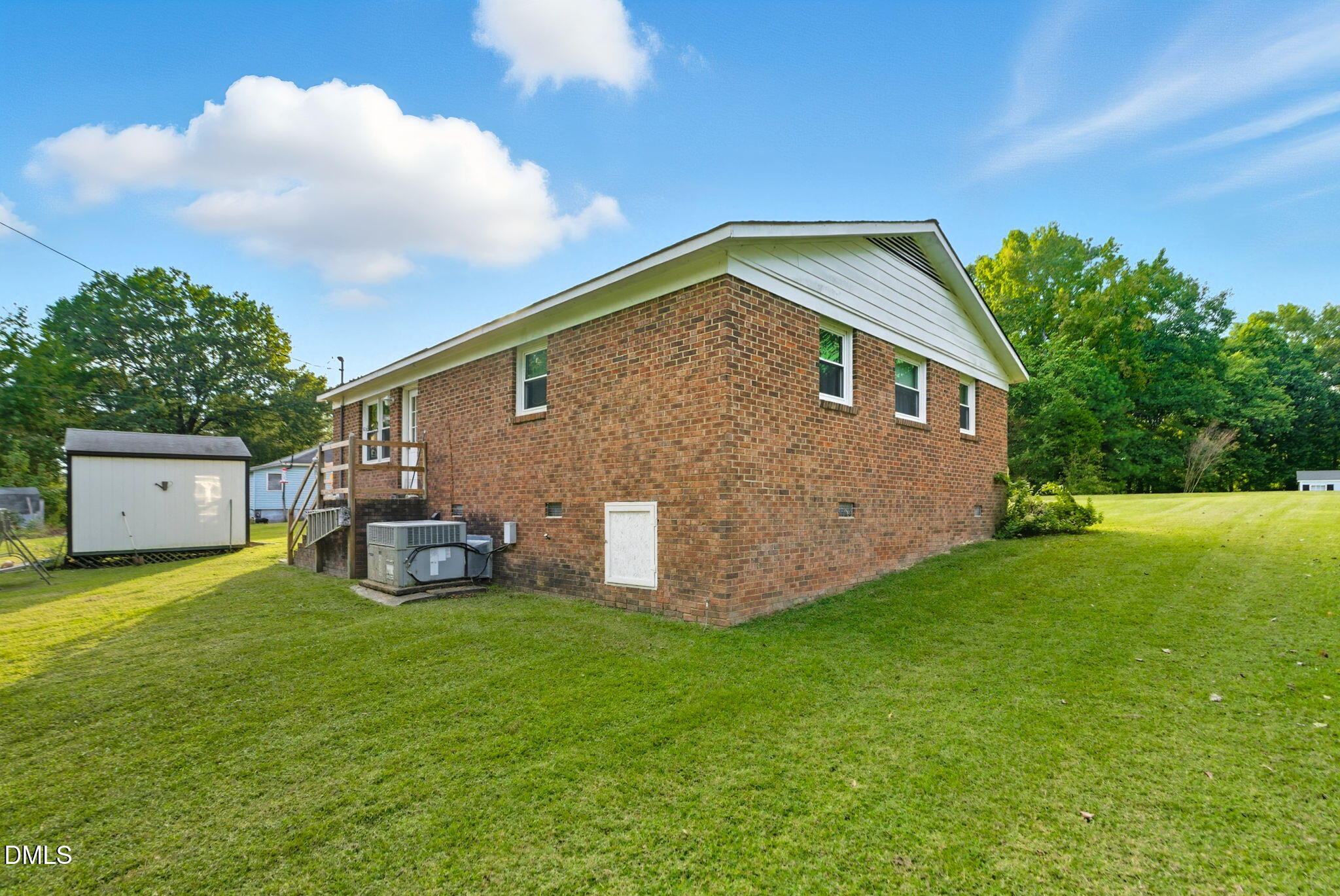 1412 Parks Village Road Zebulon, NC 27597 - Photo 34 of 40 a view of backyard with barbeque grill and brick wall