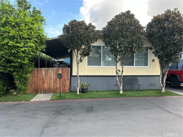 a front view of a house with a garden and garage