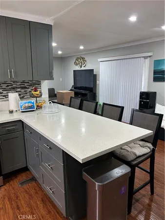 a large kitchen with a table and chairs