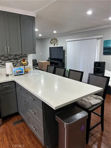 a large kitchen with a table and chairs