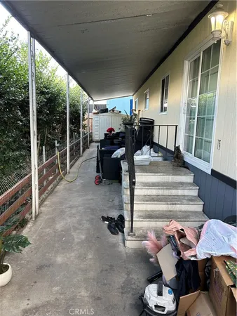a view of a porch with furniture and floor to ceiling window
