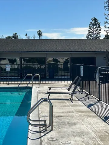 a view of a patio with table and chairs potted plants with floor to ceiling window