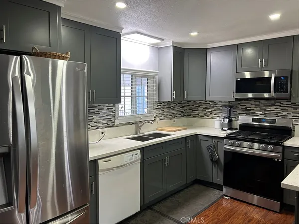 a kitchen with a sink stove and refrigerator