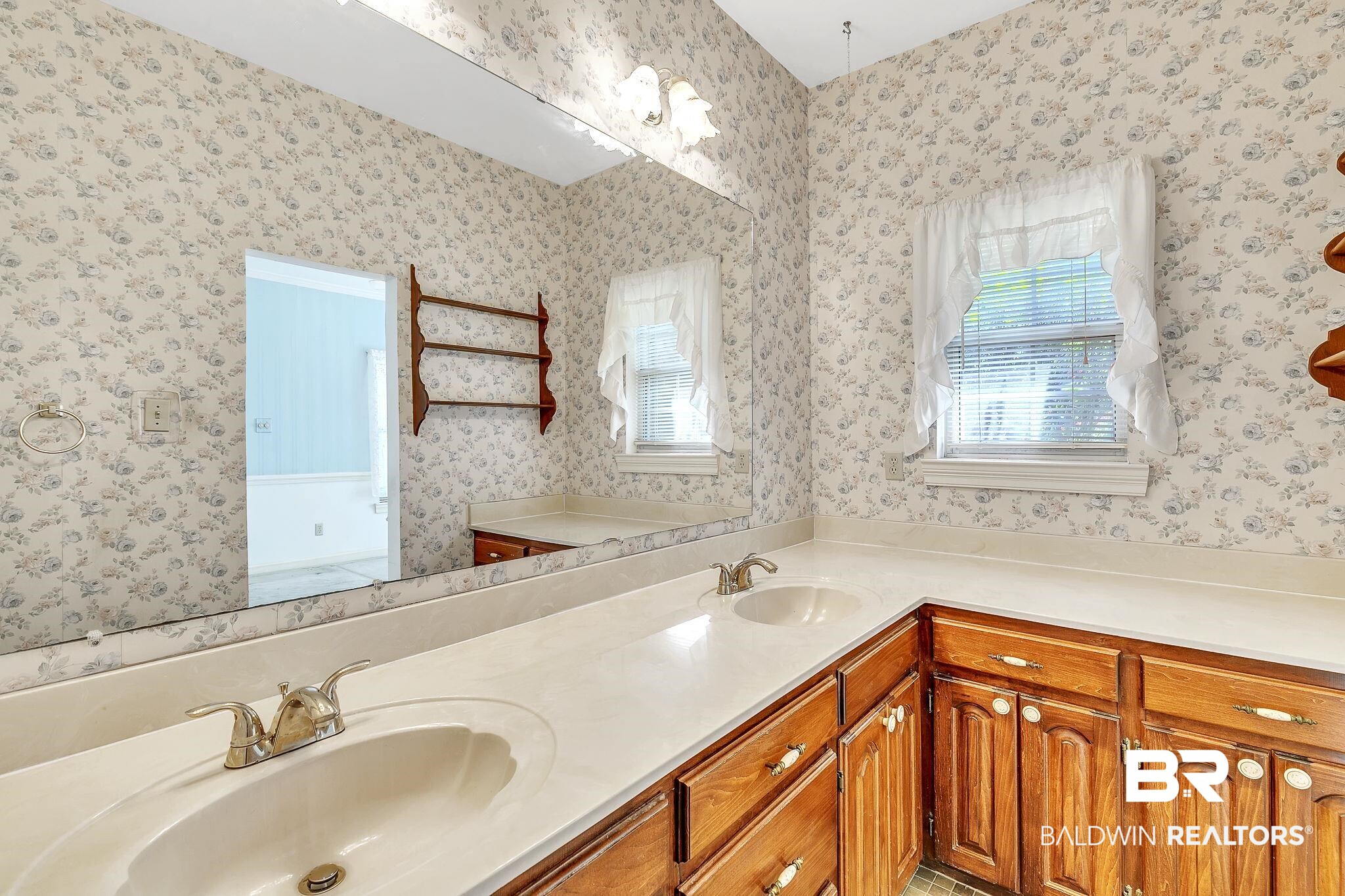 367 Ridgewood Drive Daphne, AL 36526 - Photo 42 of 71 Full bathroom featuring wallpapered walls, a sink, and a healthy amount of sunlight