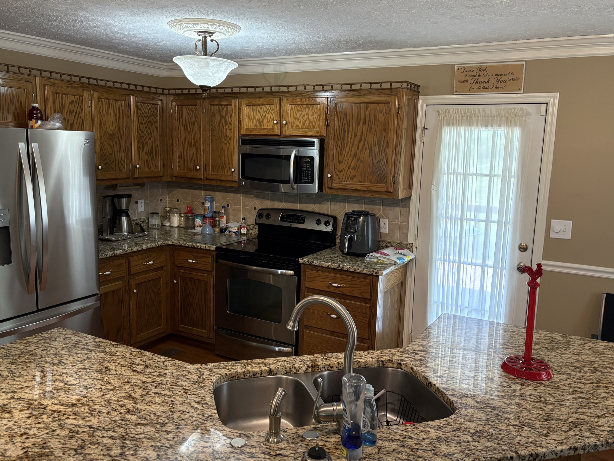 5234 Shellsford Road McMinnville, TN 37110 - Photo 13 of 59 a kitchen with stainless steel appliances granite countertop a sink stove and refrigerator