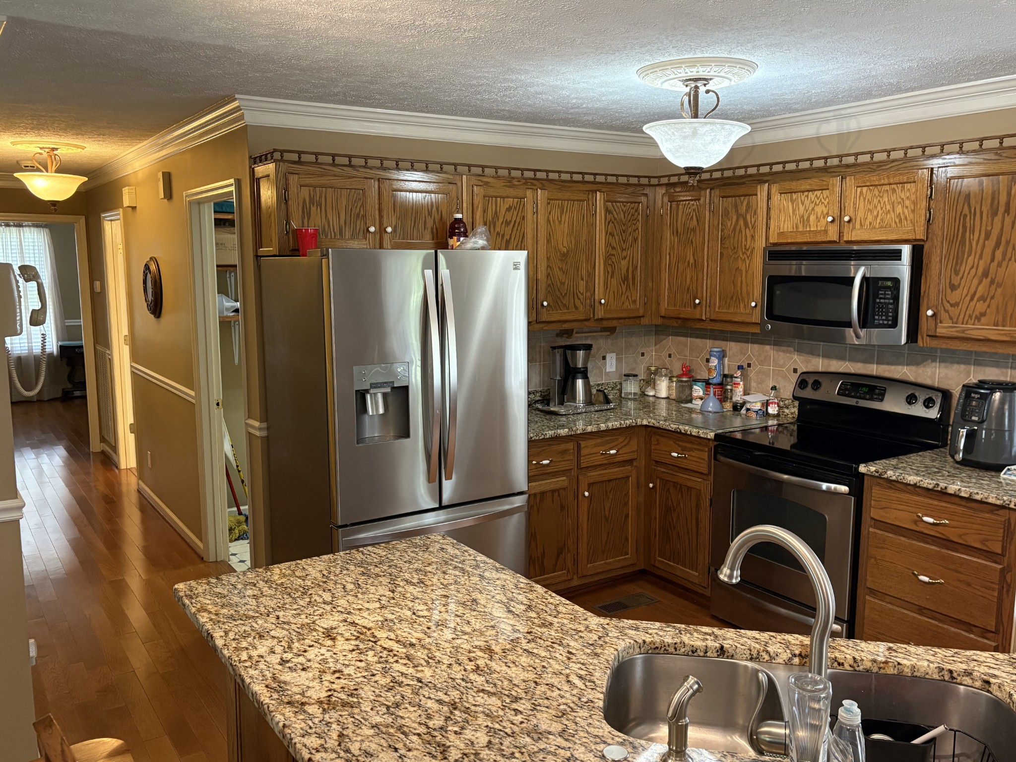 5234 Shellsford Road McMinnville, TN 37110 - Photo 14 of 59 a kitchen with granite countertop a refrigerator and a stove top oven