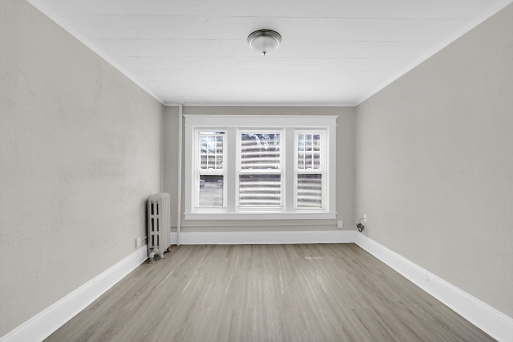 120-122 Central Street Springfield, MA 01103 - Photo 24 of 30 an empty room with wooden floor and windows