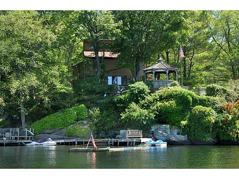 155 Reservoir Road Burrillville, RI 02859 - Photo 2 of 24 Exterior Back. Well maintained docks, private mini sand beach area, great fishing & swimming. Western exposure offers fantastic sunset experiences.