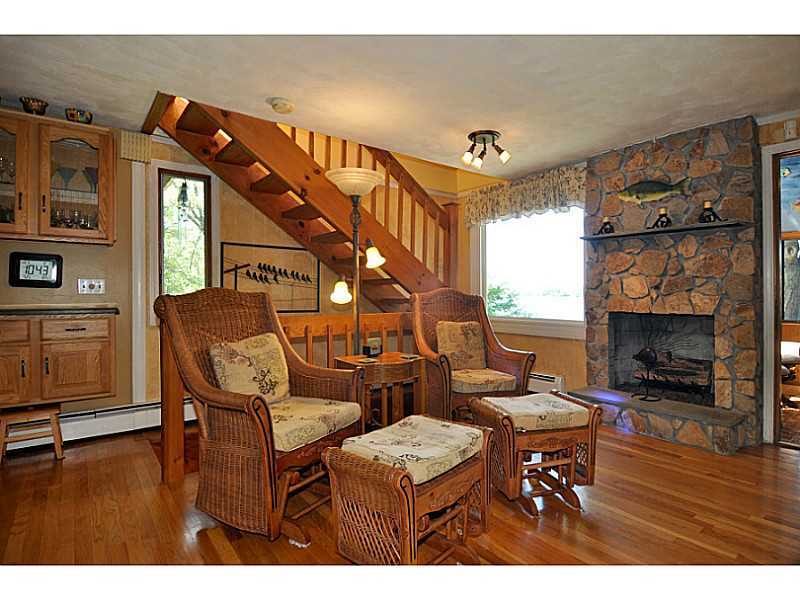 155 Reservoir Road Burrillville, RI 02859 - Photo 7 of 24 Den/Family/Great Room. Beautiful lake views and stone front fireplace makes it even more magical.