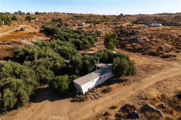 an aerial view of a house with a yard