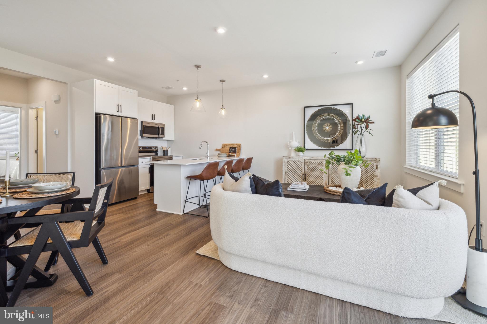 a living room with furniture and kitchen view