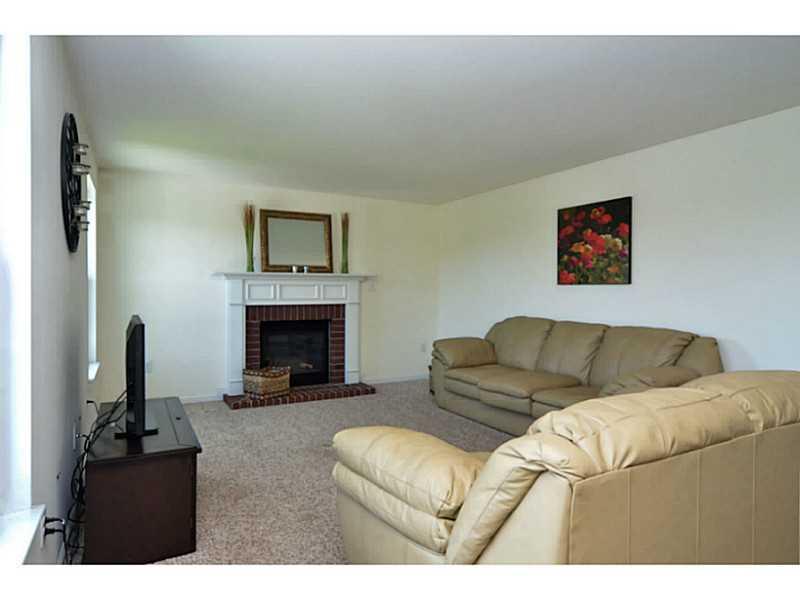 113 Walnut Drive McKees Rocks, PA 15136 - Photo 5 of 21 Family Room. The family room includes a gas fireplace with brick surround.