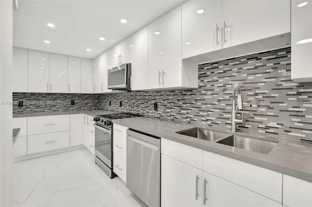 a kitchen with stainless steel appliances granite countertop a sink and cabinets
