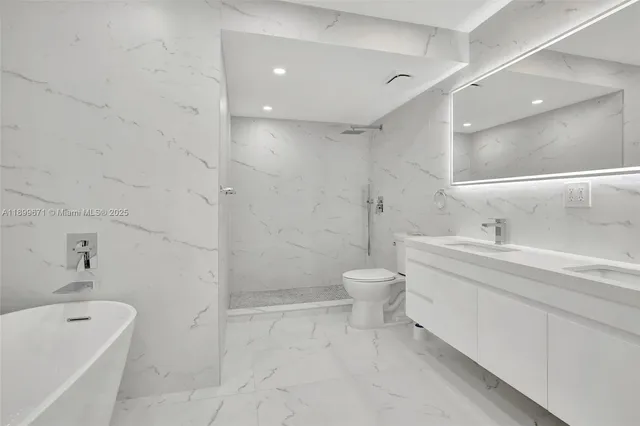 a bathroom with a toilet sink shower and bathtub