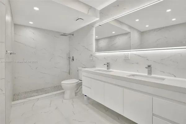 a bathroom with a sink toilet and a mirror