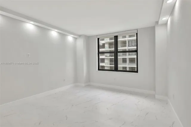 a view of an empty room with a window