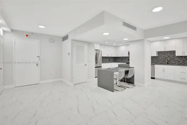 a view of a kitchen with sink and microwave