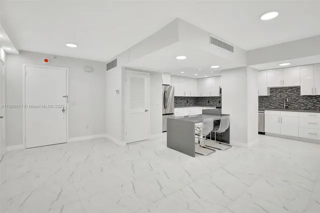 a view of a kitchen with sink and microwave